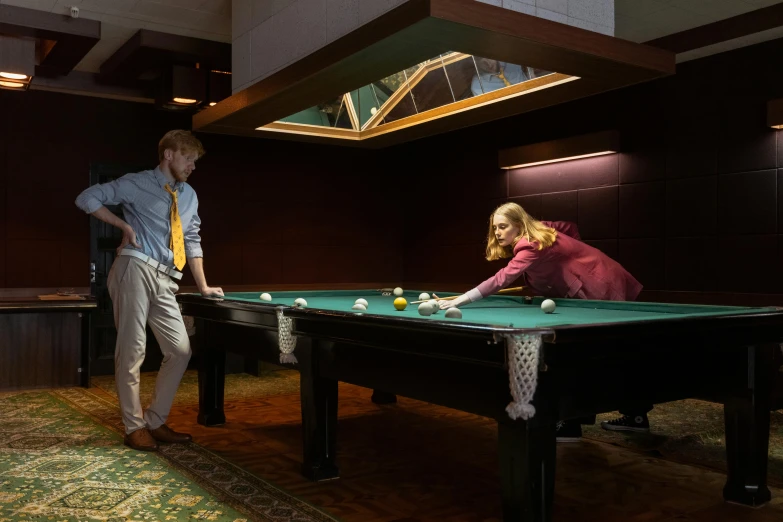 a man and a woman playing a game of pool