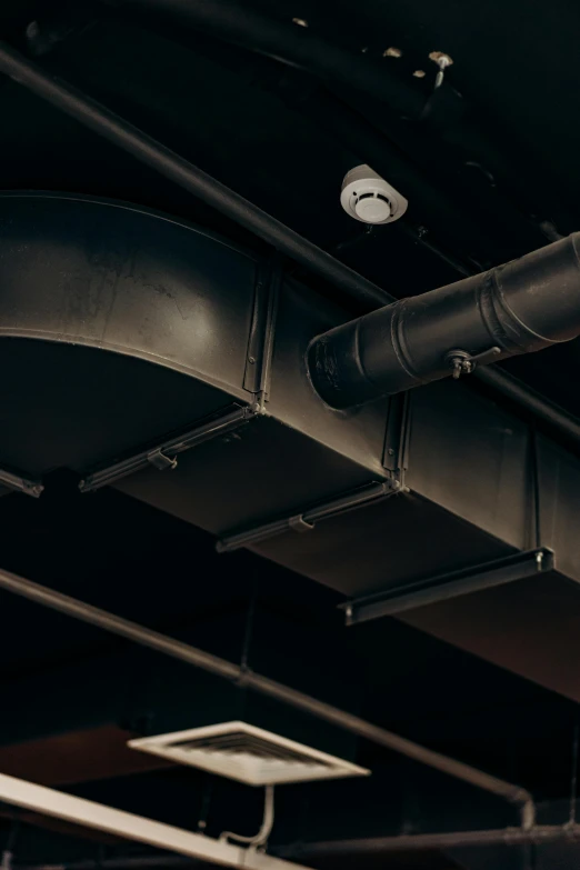 a smoke machine with a fire extinguisher mounted on the ceiling