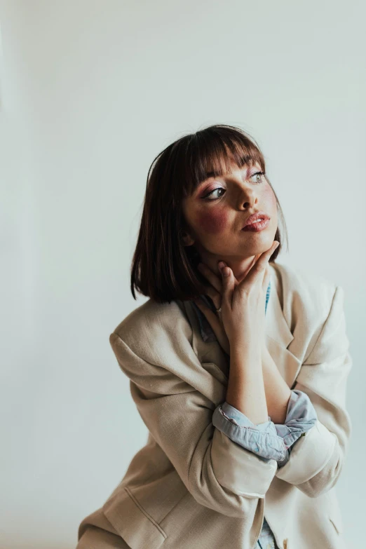 an image of a woman in white blazer posing for a po