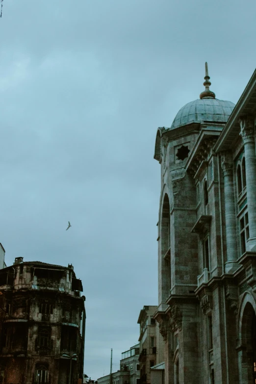 two very old buildings that are sitting side by side