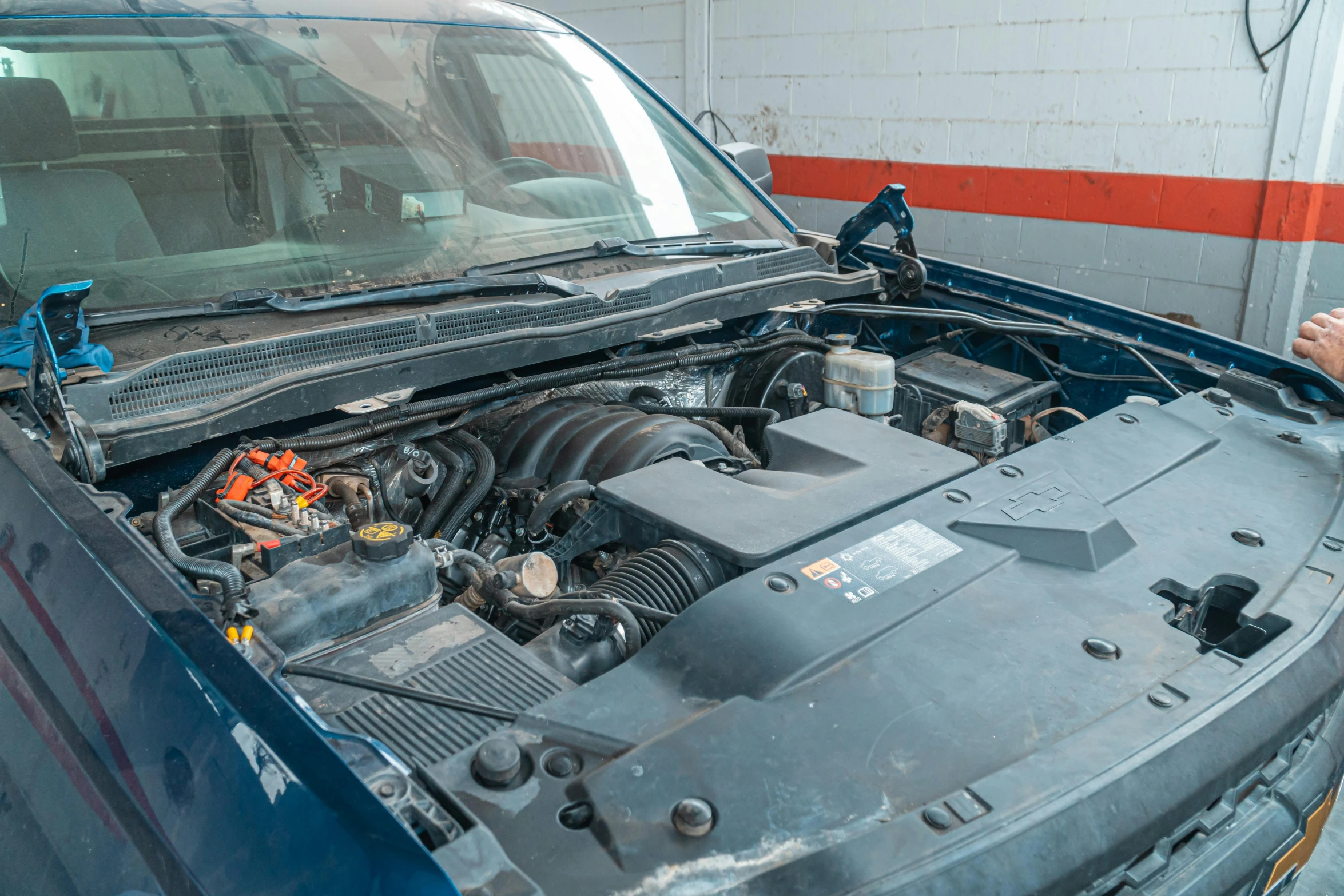 a car engine is shown with a hose hooked to the hood