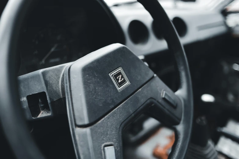 a close up view of the interior of a car with the steering wheel and dash panel in the center