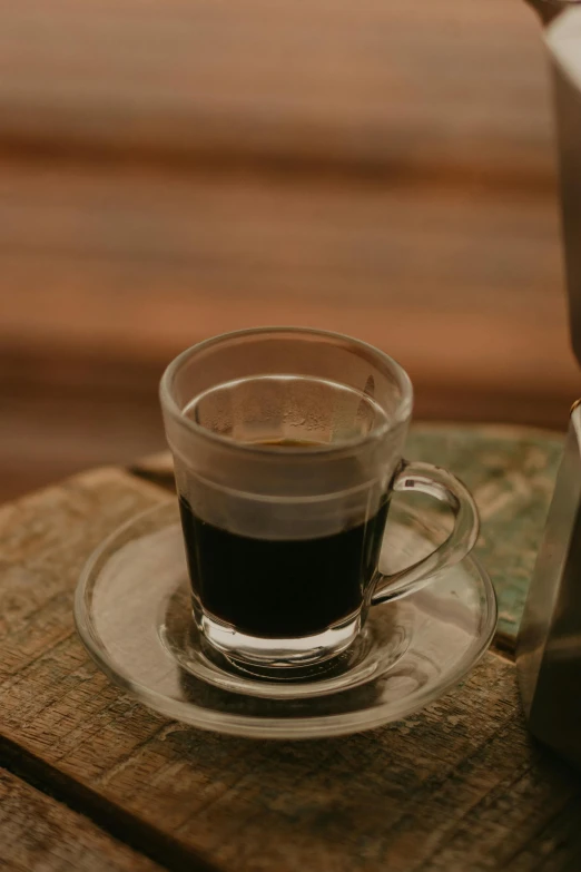 a small cup of coffee on a saucer