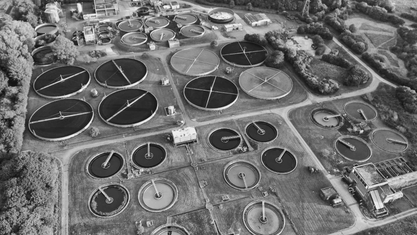 an aerial view of the outside of a large factory with tanks