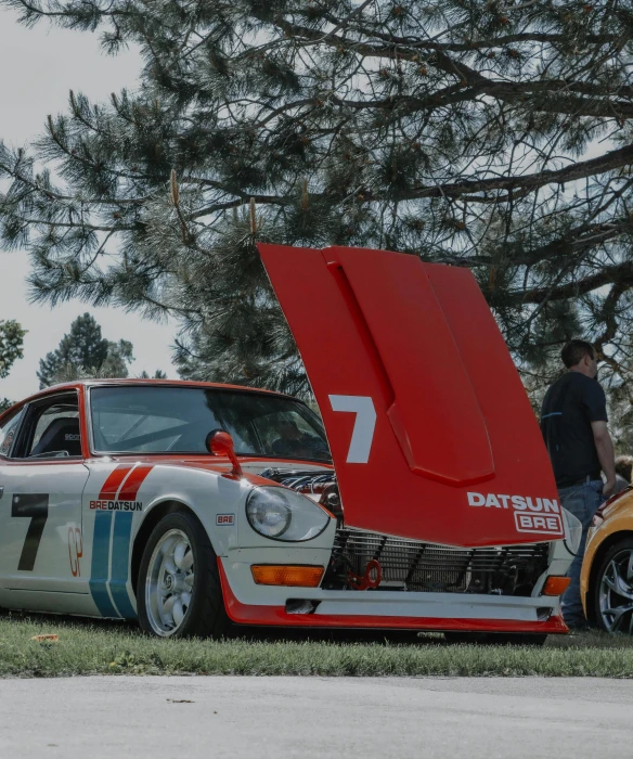 an old vintage racing car with the hood open