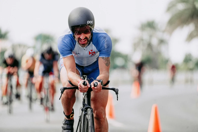 a man riding a bicycle on a wet road