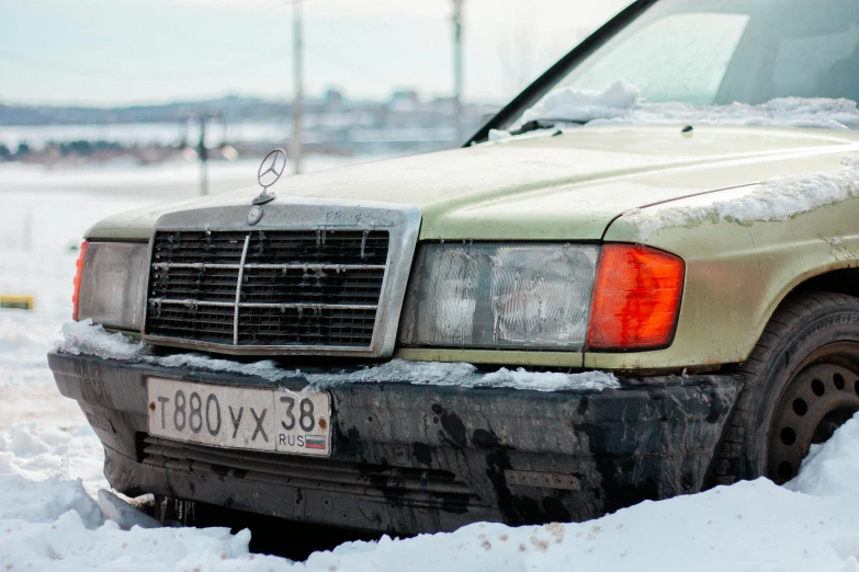 a dirty truck that has been abandoned in the snow