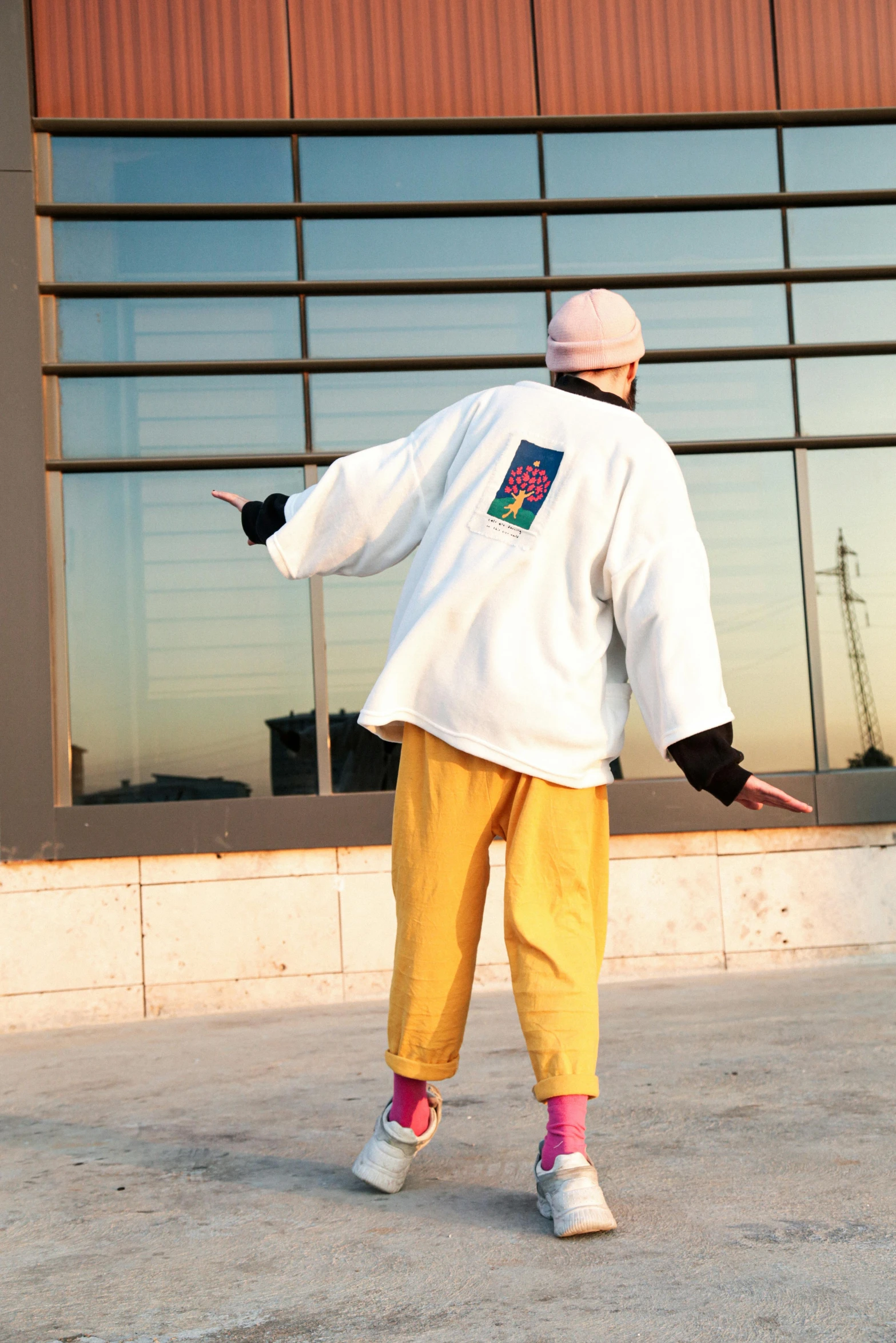 a man standing on top of a cement slab near a building