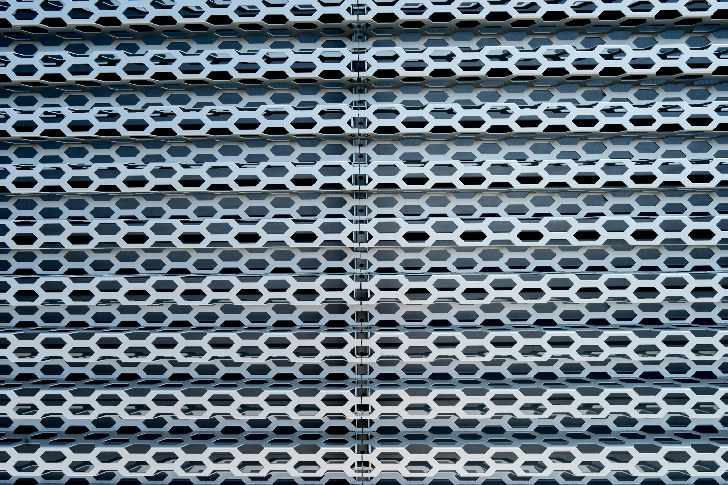 the outside of a metal fence with holes