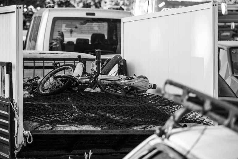 two bikes are parked in the back of a truck