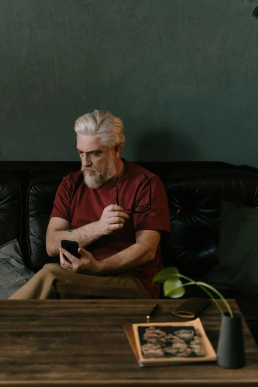 a man sitting on top of a couch in a living room