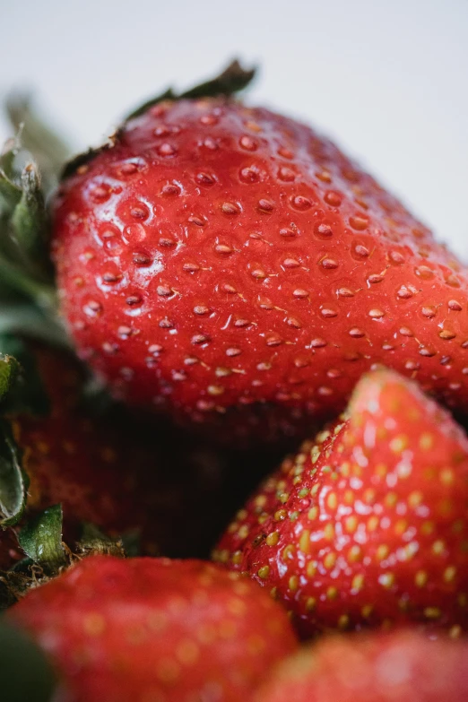 a closeup s of strawberries that are ripe and sit on a table