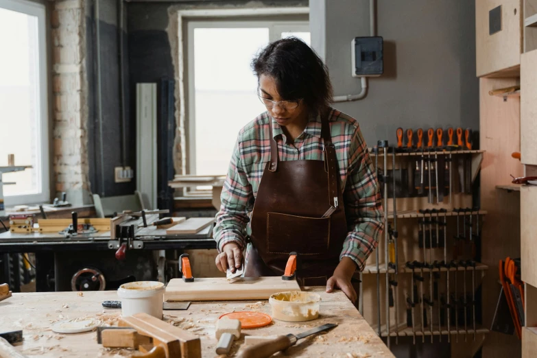 an individual working in a carpner's shop in the daytime