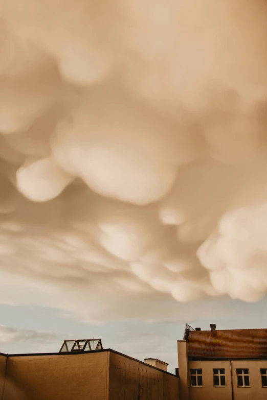 some white clouds are above some buildings