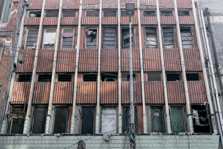 a tall building with windows and wooden slats