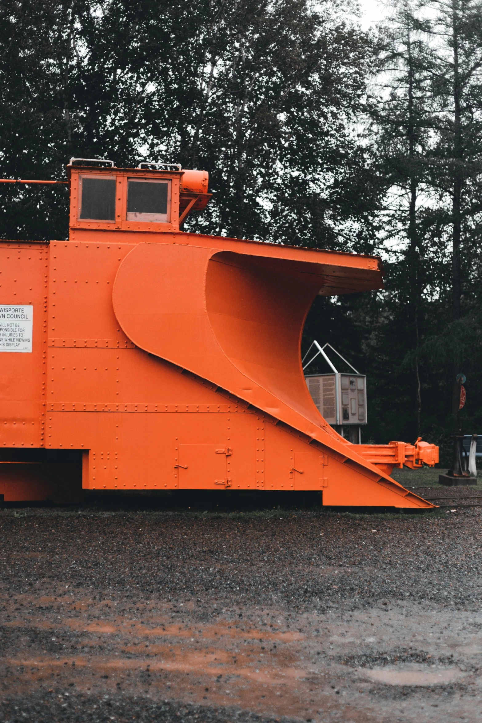 a large orange structure sitting in the middle of a park