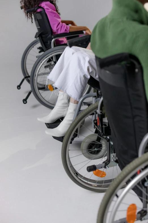 a row of people in wheelchairs on the floor