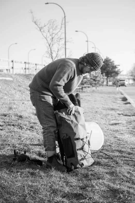 a man who is bending over in the grass