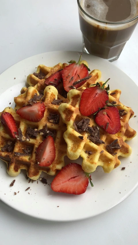 the waffles are covered with strawberries and chocolate chips