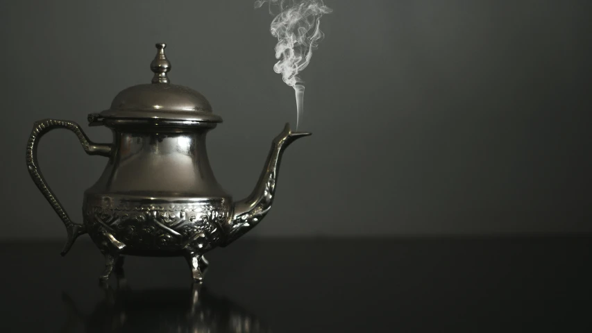 a coffee pot with steam rising out of it