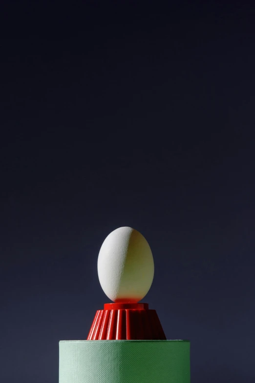 an object on top of a green and red pedestal