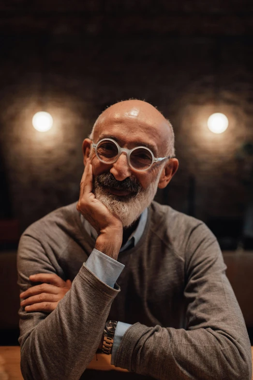 an older man with glasses looking at the camera