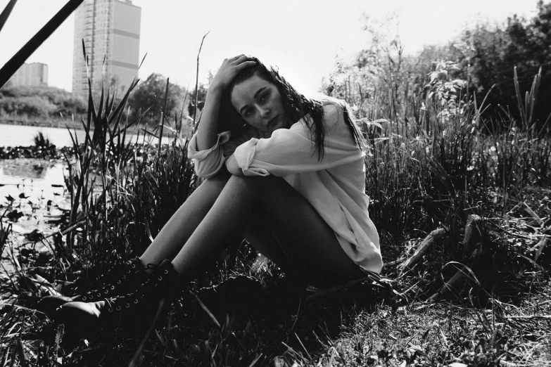 girl with hands on knees in grassy field