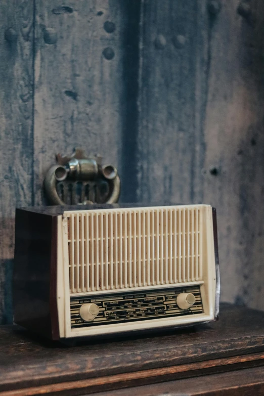 a brown old fashioned radio on a wooden table