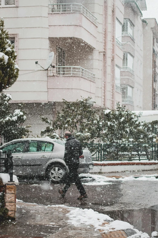 two people walking down a snow covered street