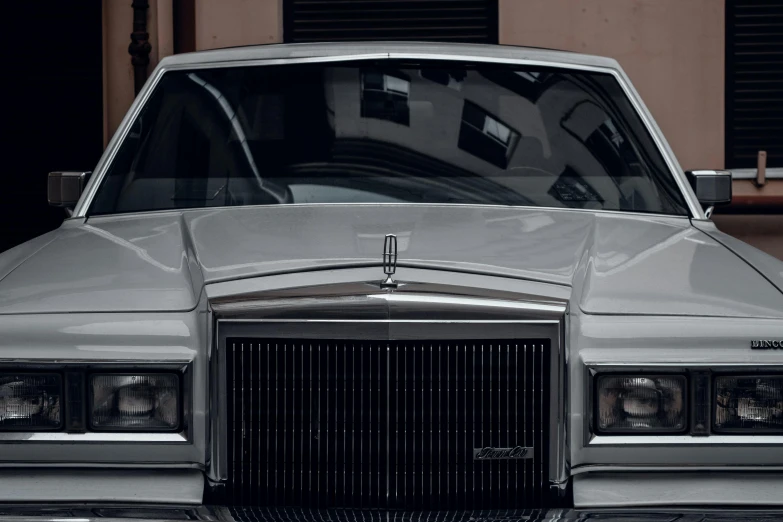 a white car with an emblem on the hood