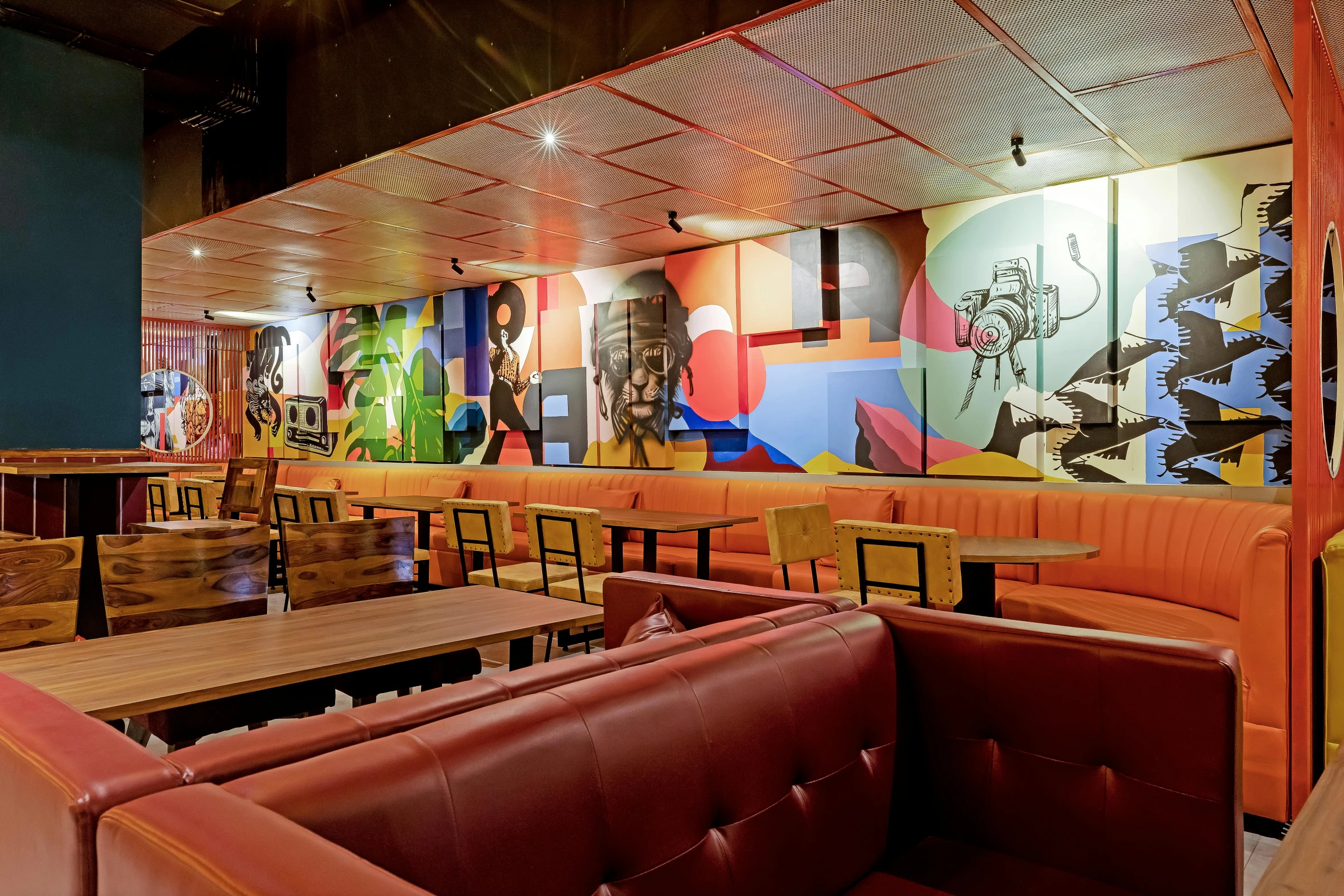 the booths in the restaurant are covered in colorful panels