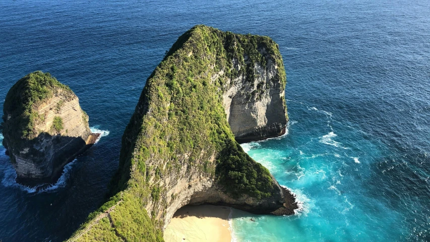 the green cliffs on the ocean and blue water