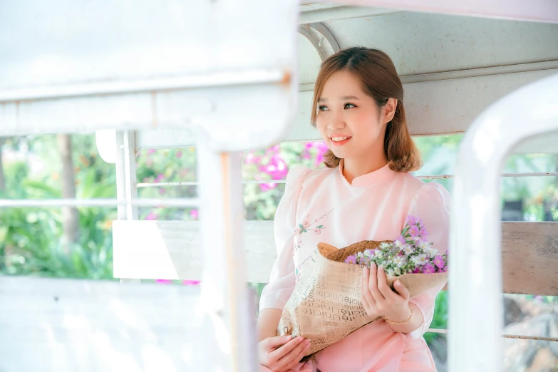 an asian woman holding a flower bouquet with her hand