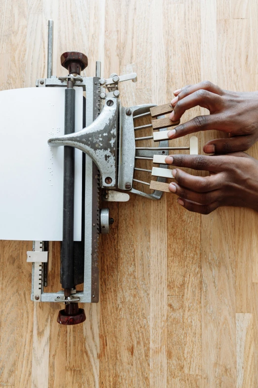 someone working on an object with multiple pieces of steel and plywood