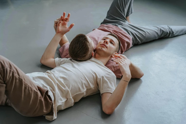 the boy is laying down on the floor next to his mother