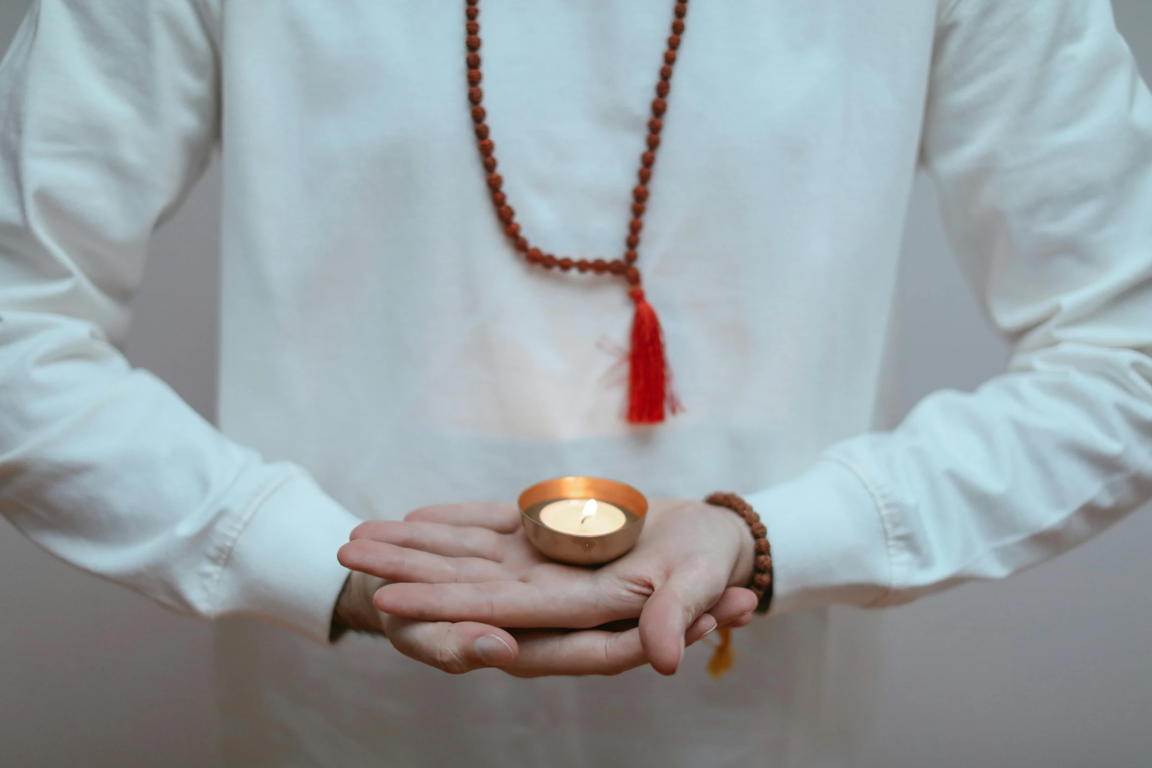 a person holding an object in their hand with a candle in it