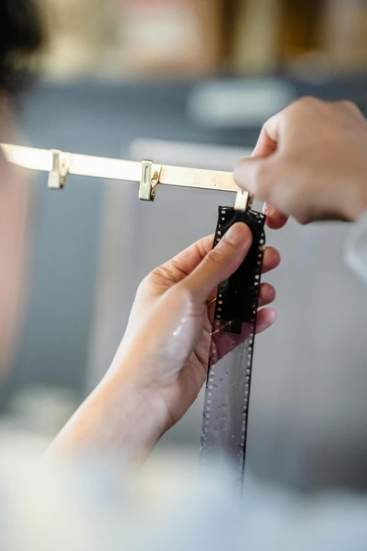 a person holding a camera with metal strips on it