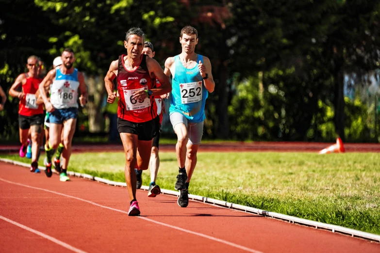 a group of men run on a track