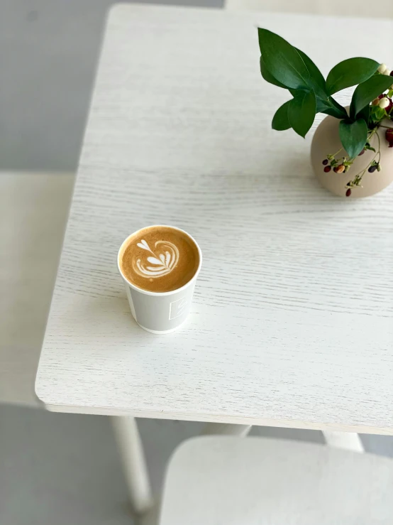 a coffee cup that is on top of a table