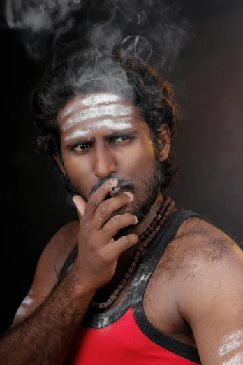 a man with his eyes closed and smoking
