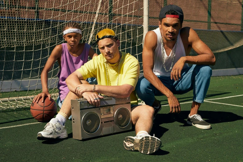 three men wearing headbands sitting next to an mp3 player