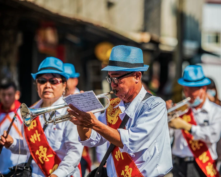 a band with blue hats and red flags