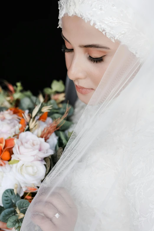 bride holding a bouquet of flowers and dressed up