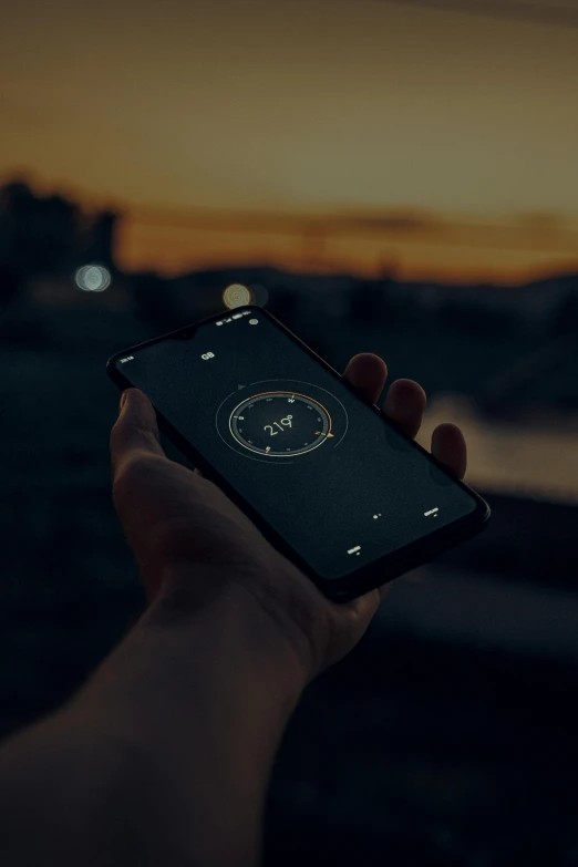 a person is holding up a phone in front of the sky