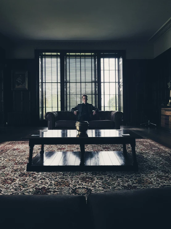 a man sitting on a couch in the middle of a living room