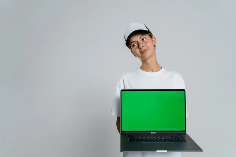 a nurse is holding up a green laptop