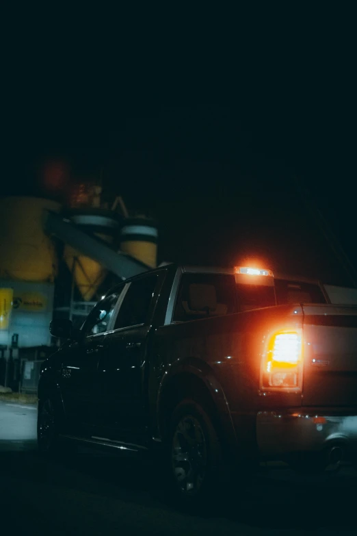 a truck at night with the light on driving