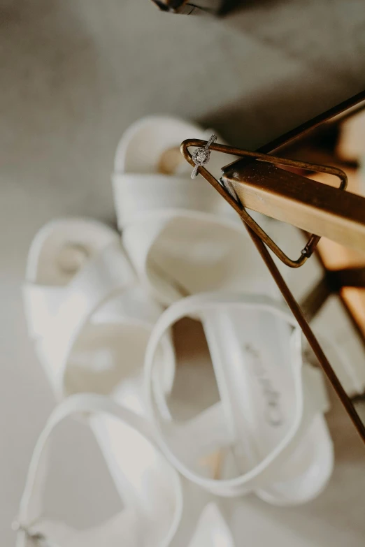 white shoes with clear straps sit on a floor