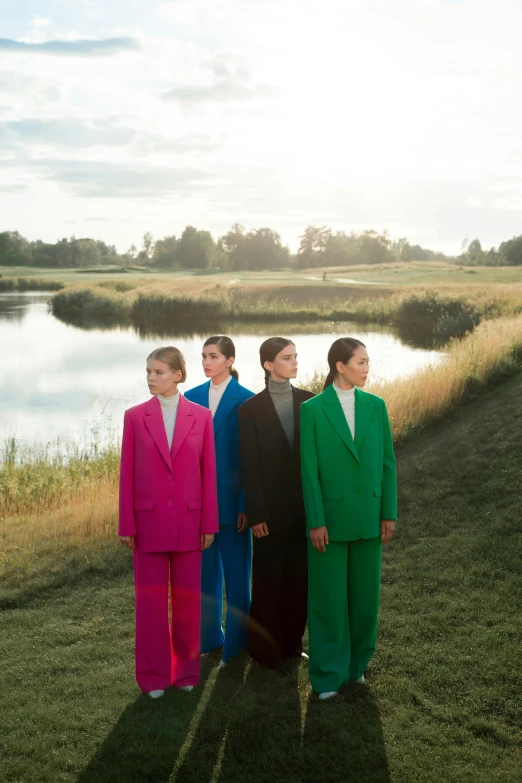 three men in bright colored suits posing for a po