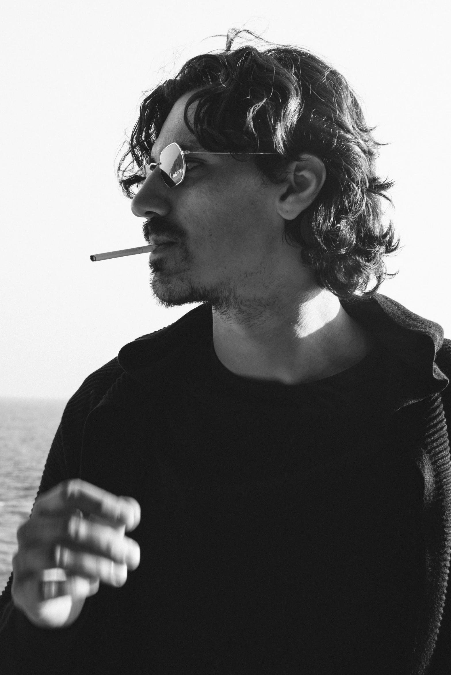 a man smoking a cigarette on a boat